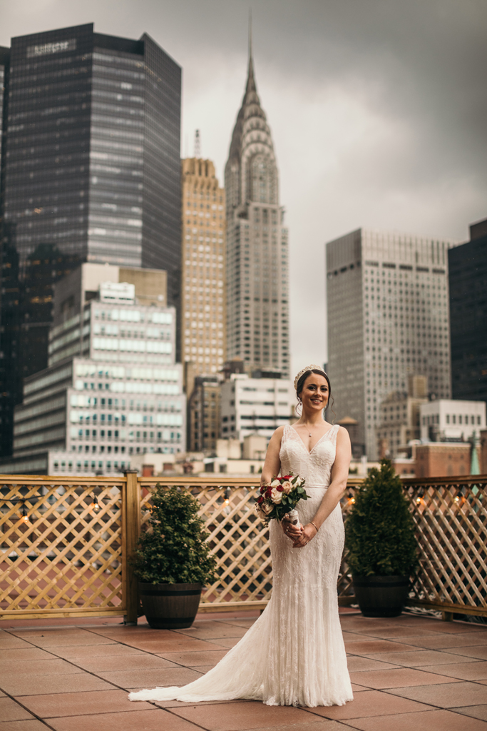 Bride on Manhattan rooftop holding bouquet